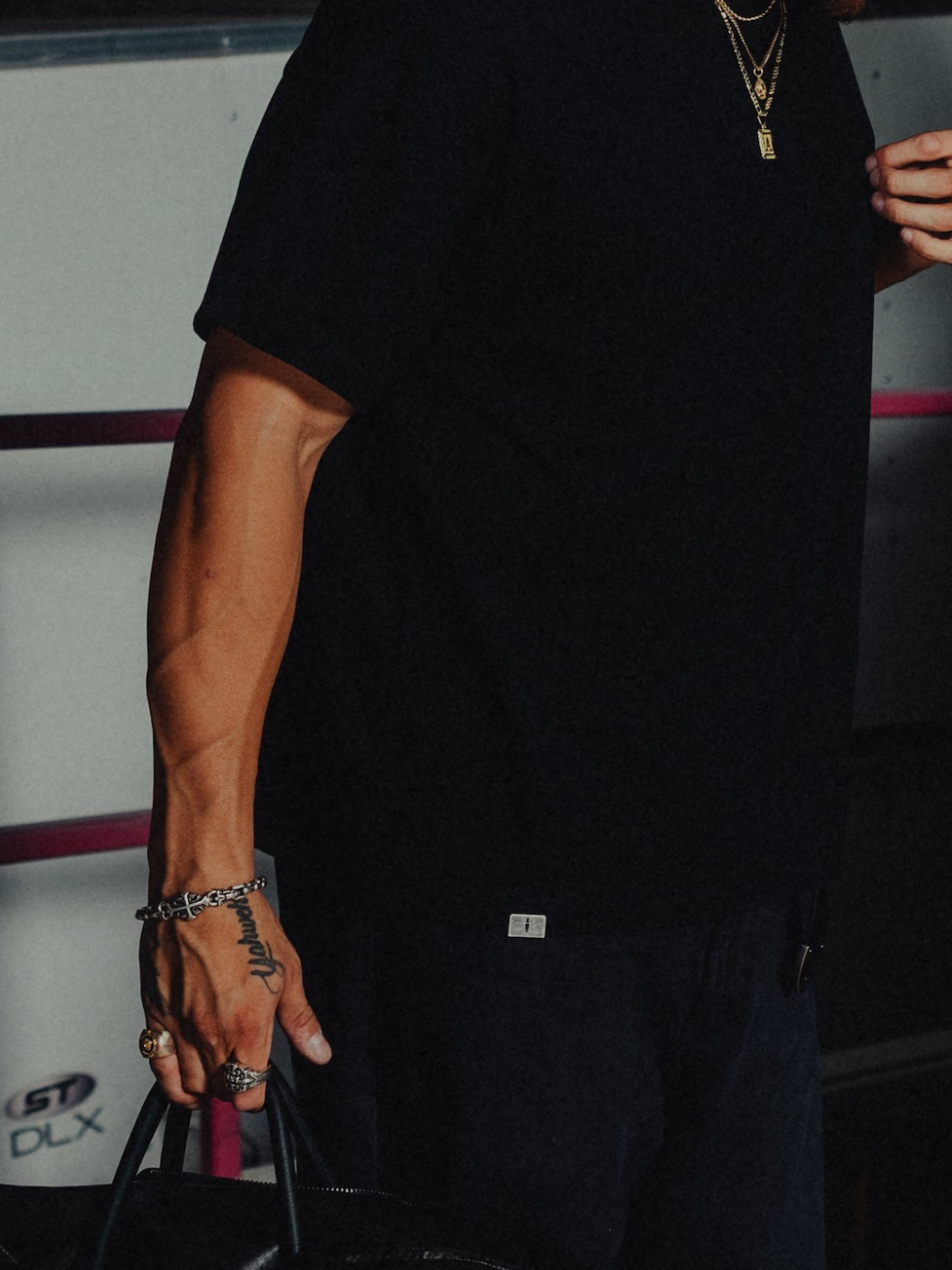 Model in the black classic crew tee, metal tab at the hem