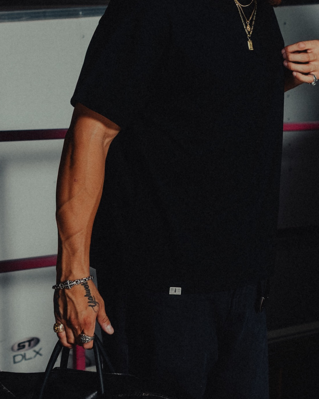 Model in the black classic crew tee, metal tab at the hem