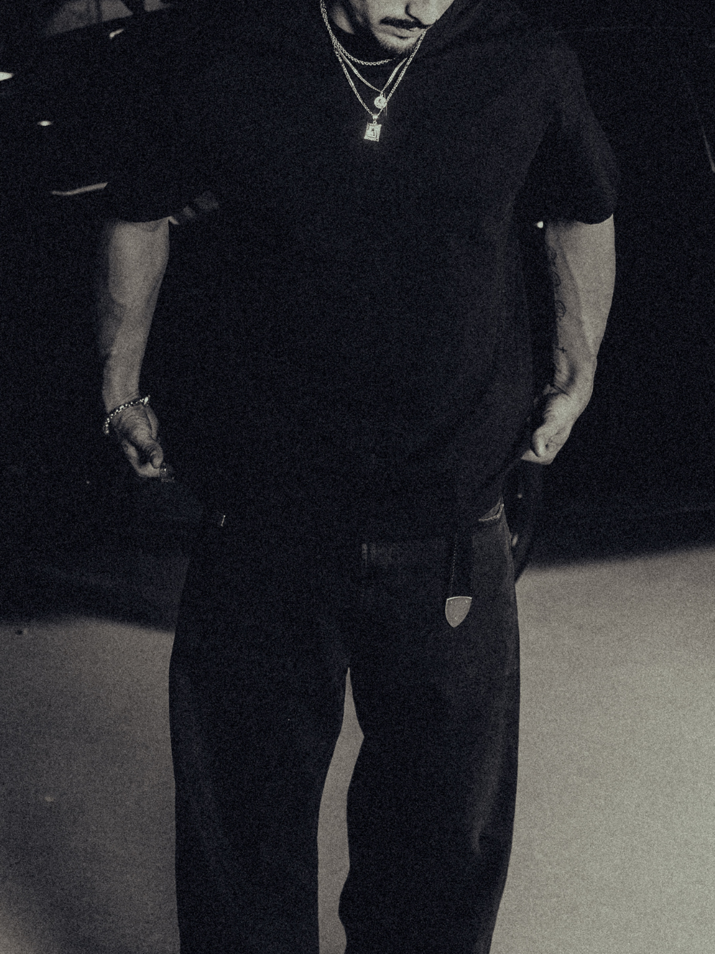 Model in the black classic crew tee with gold chains