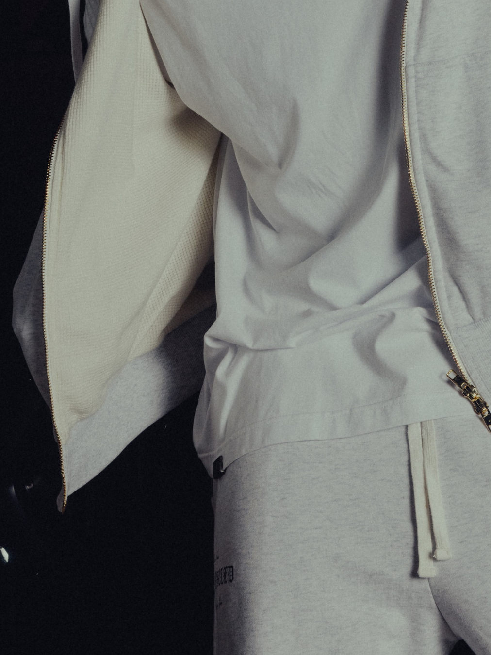 Waffle-knit lining and dual golden zip on the open hoodie