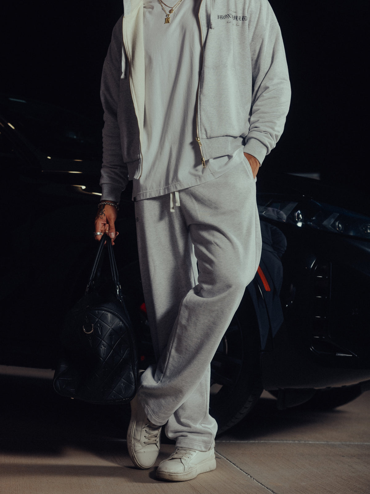 Model walking in the Heritage hoodie and relaxed sweatpants