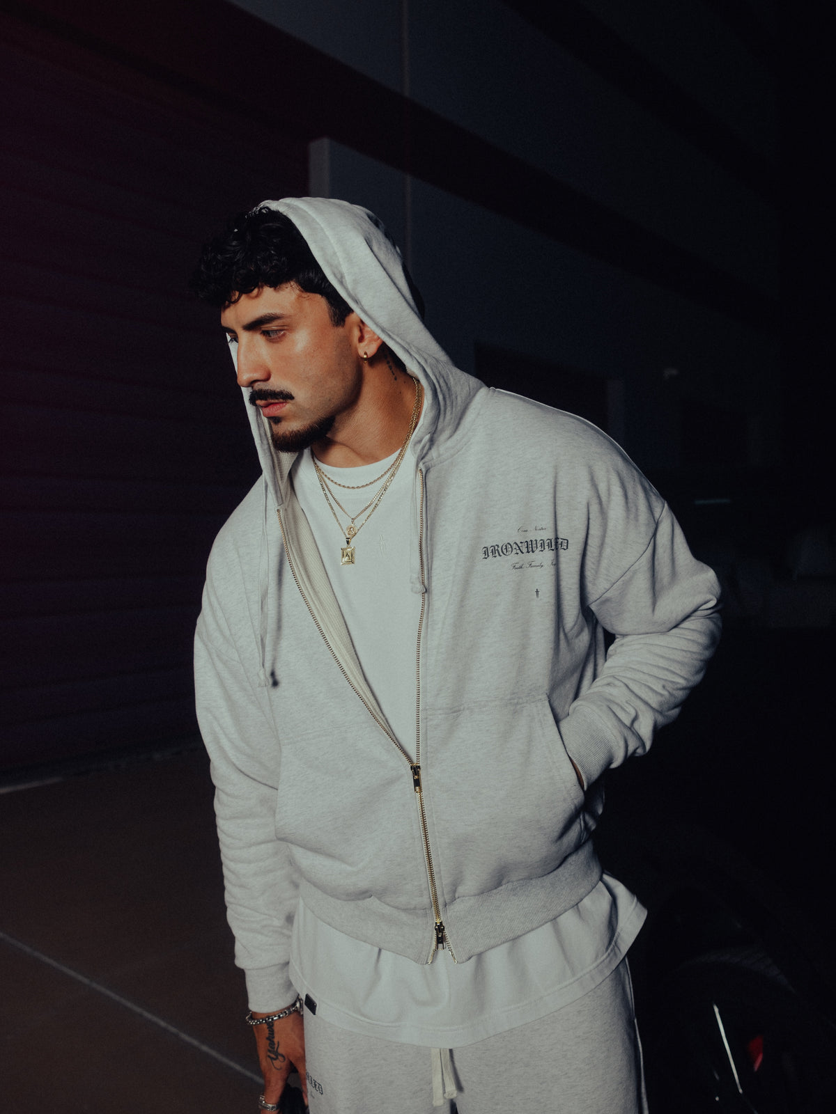 Model in the Heritage zip hoodie and relaxed sweatpants