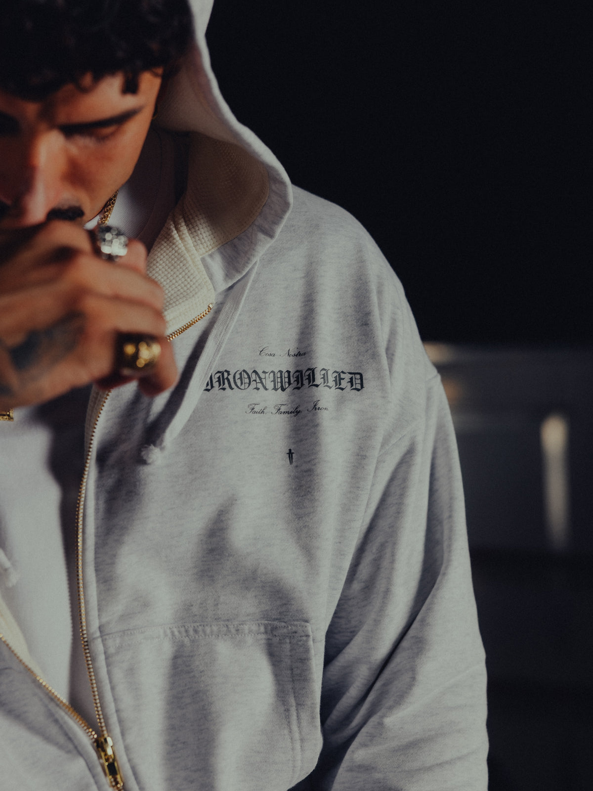Close-up of the Ironwilled chest graphic and golden zip on the Heritage hoodie