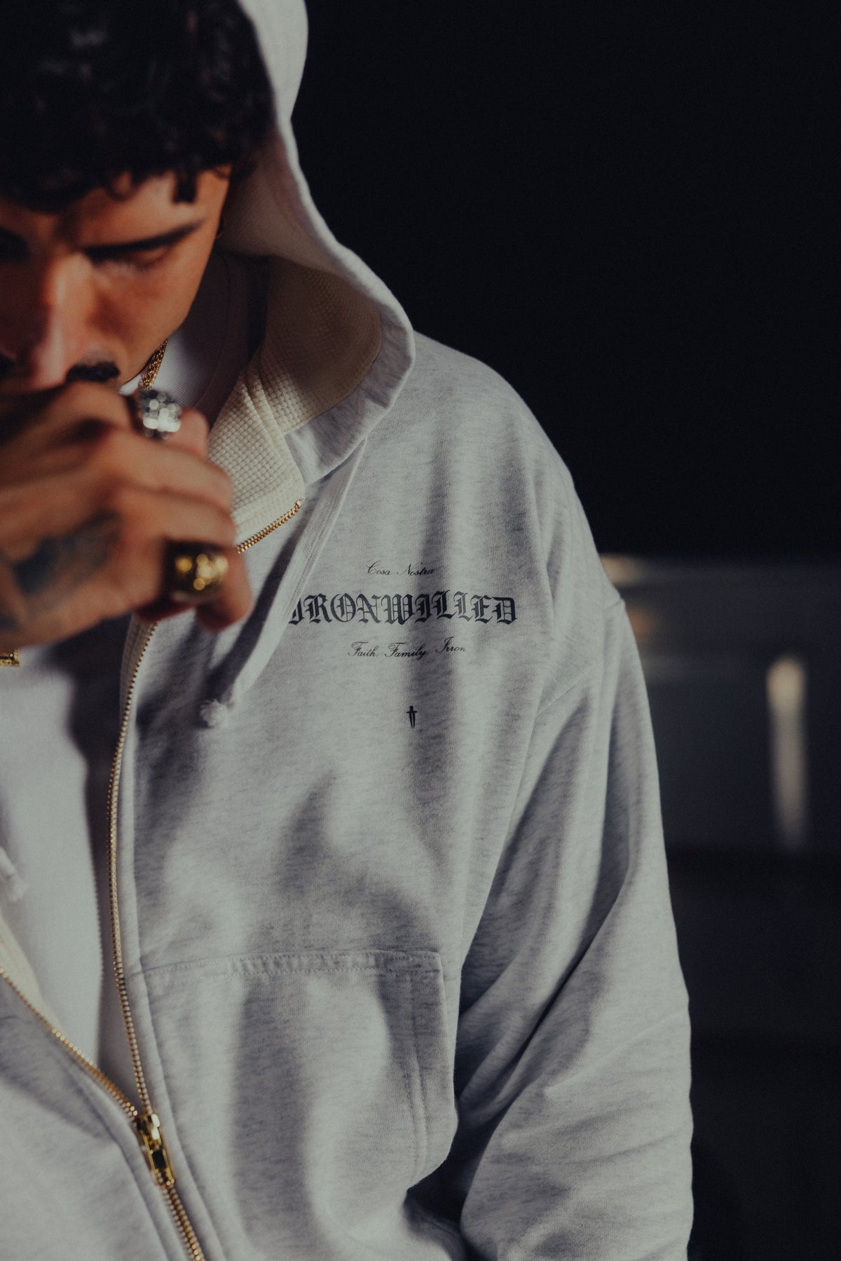 Close-up of the Ironwilled chest graphic and golden zip on the Heritage hoodie