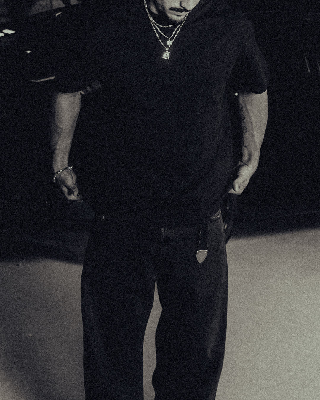 Model in the black classic crew tee with gold chains