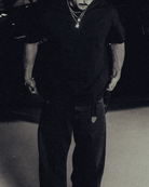 Model in the black classic crew tee with gold chains