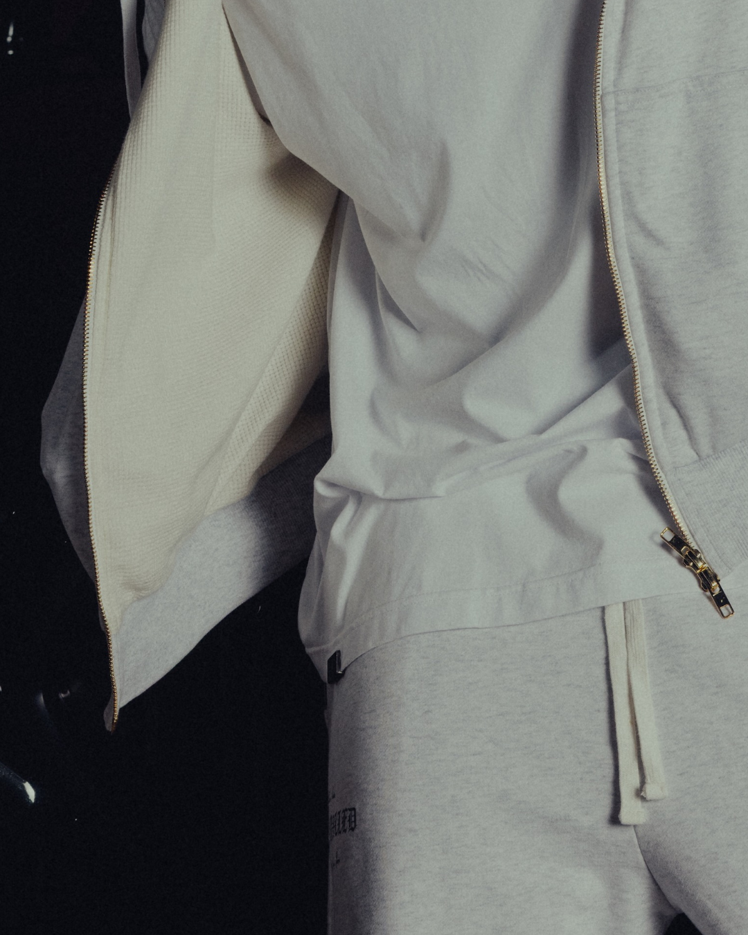 Waffle-knit lining and dual golden zip on the open hoodie