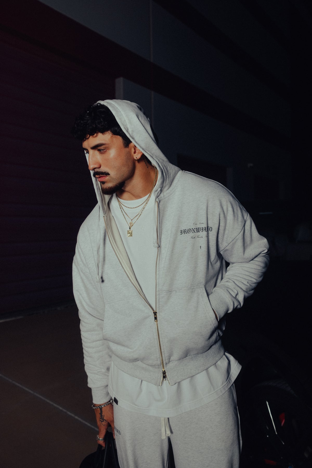 Model in the Heritage zip hoodie and relaxed sweatpants