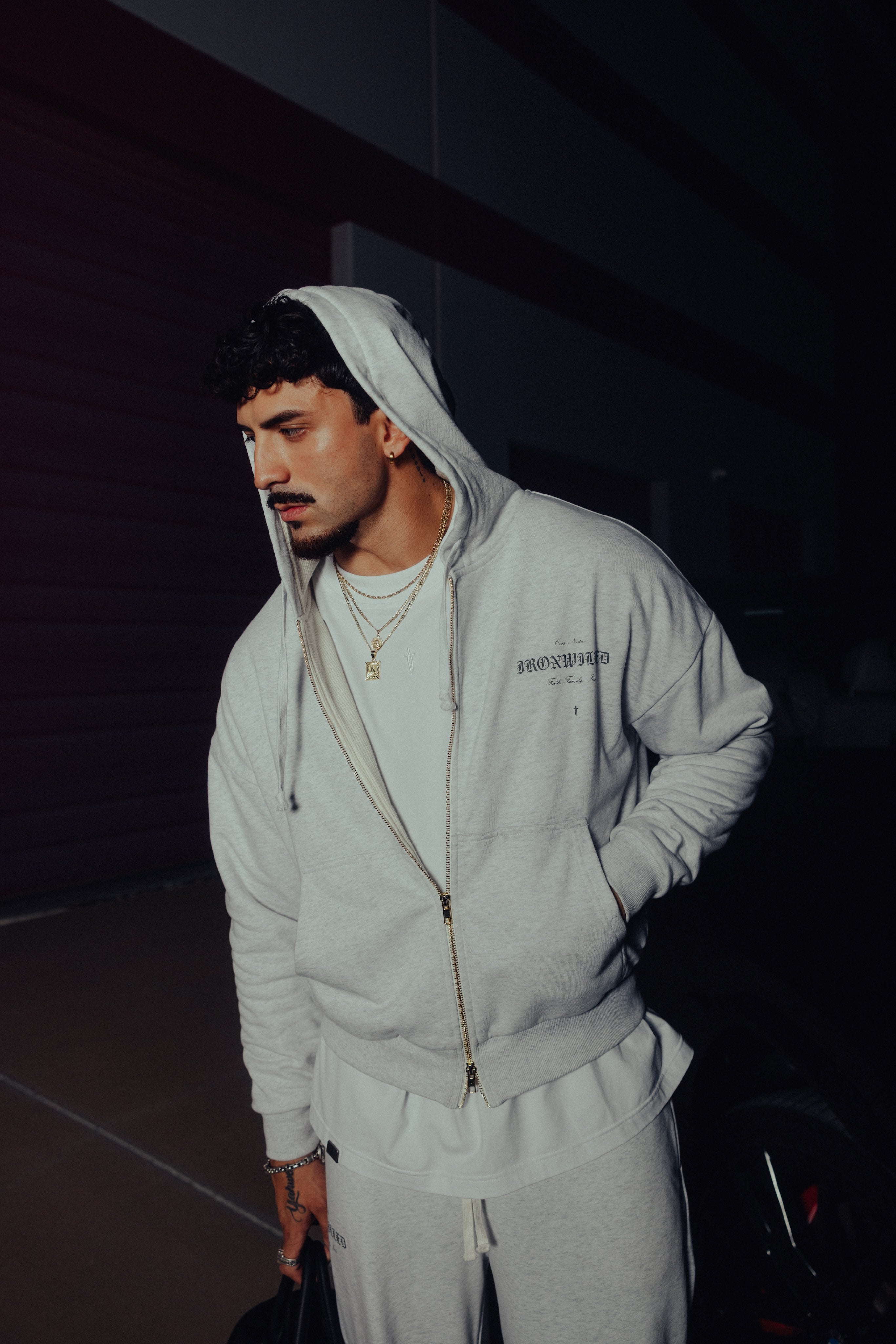 Model wearing the heather grey Heritage zip hoodie with the hood up