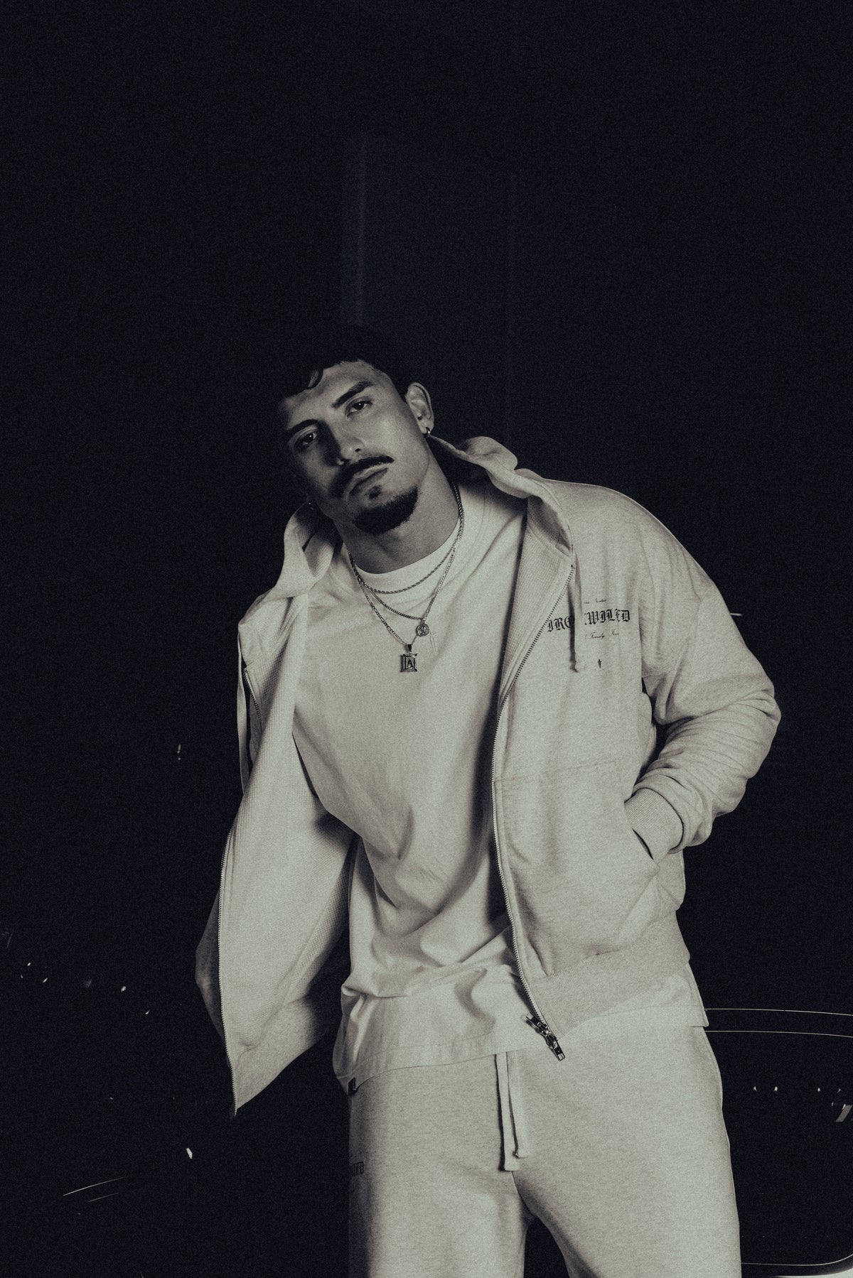 Model in the Heritage zip hoodie, hands in pockets
